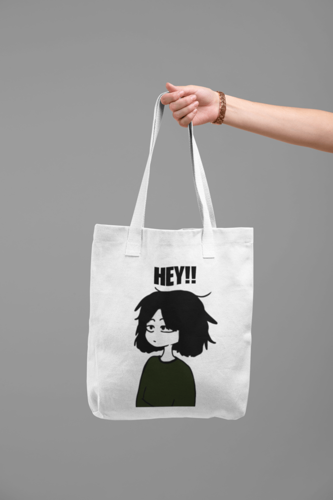 tote bag mockup being held by a hand against a flat magenta surface 28830